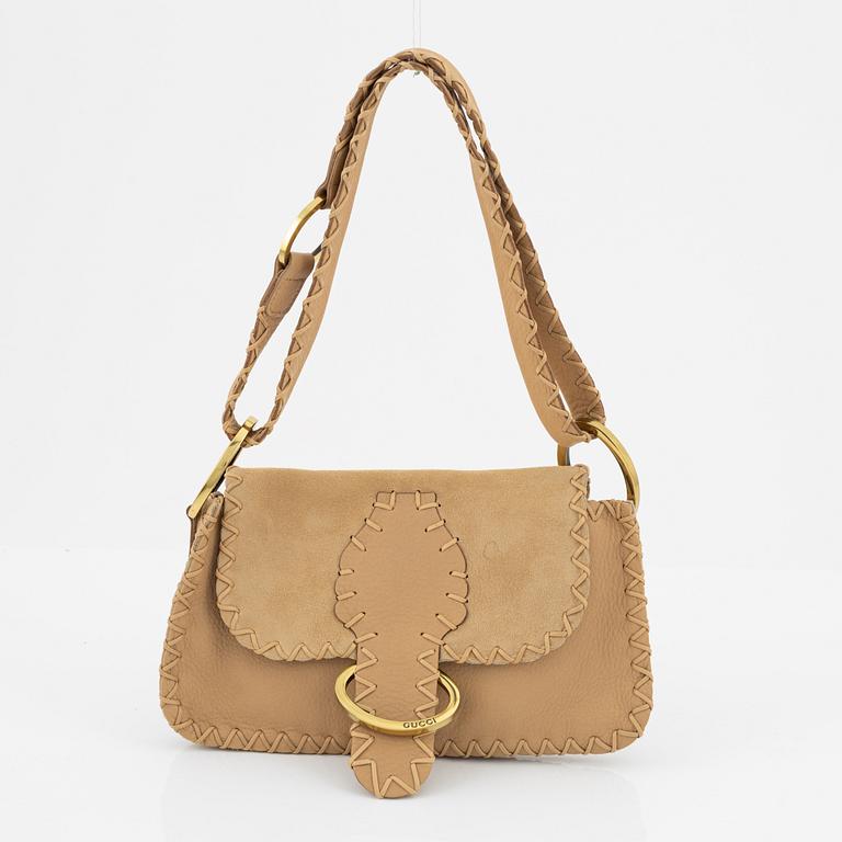 Gucci, a suede handbag.