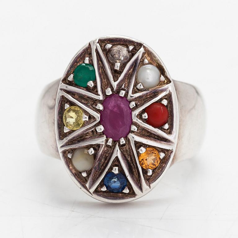 A sterling silver ring with multicoloured precious stones.