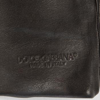 DOLCE & GABBANA, a black leather scarf with ends in the shape of gloves.
