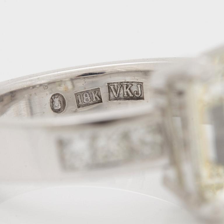 A RING set with an emerald-cut diamond.