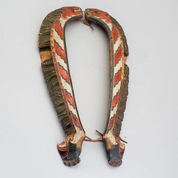 A pair of carved and painted folk art horse hames 18/19th century.