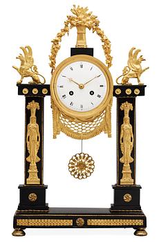 665. A French Louis XVI late 18th century gilt bronze and marble mantel clock.
