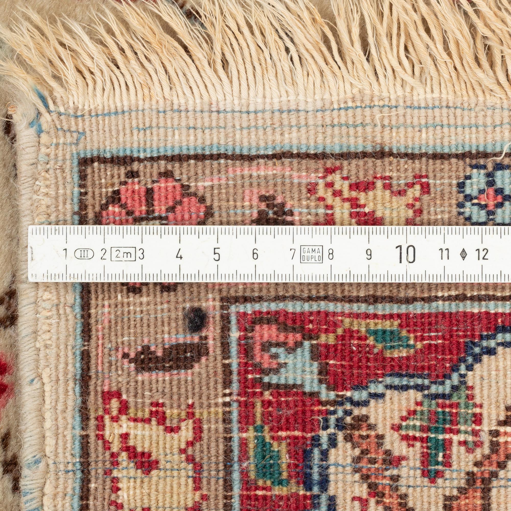 An oriental, figural rug, c. 230 x 145 cm.
