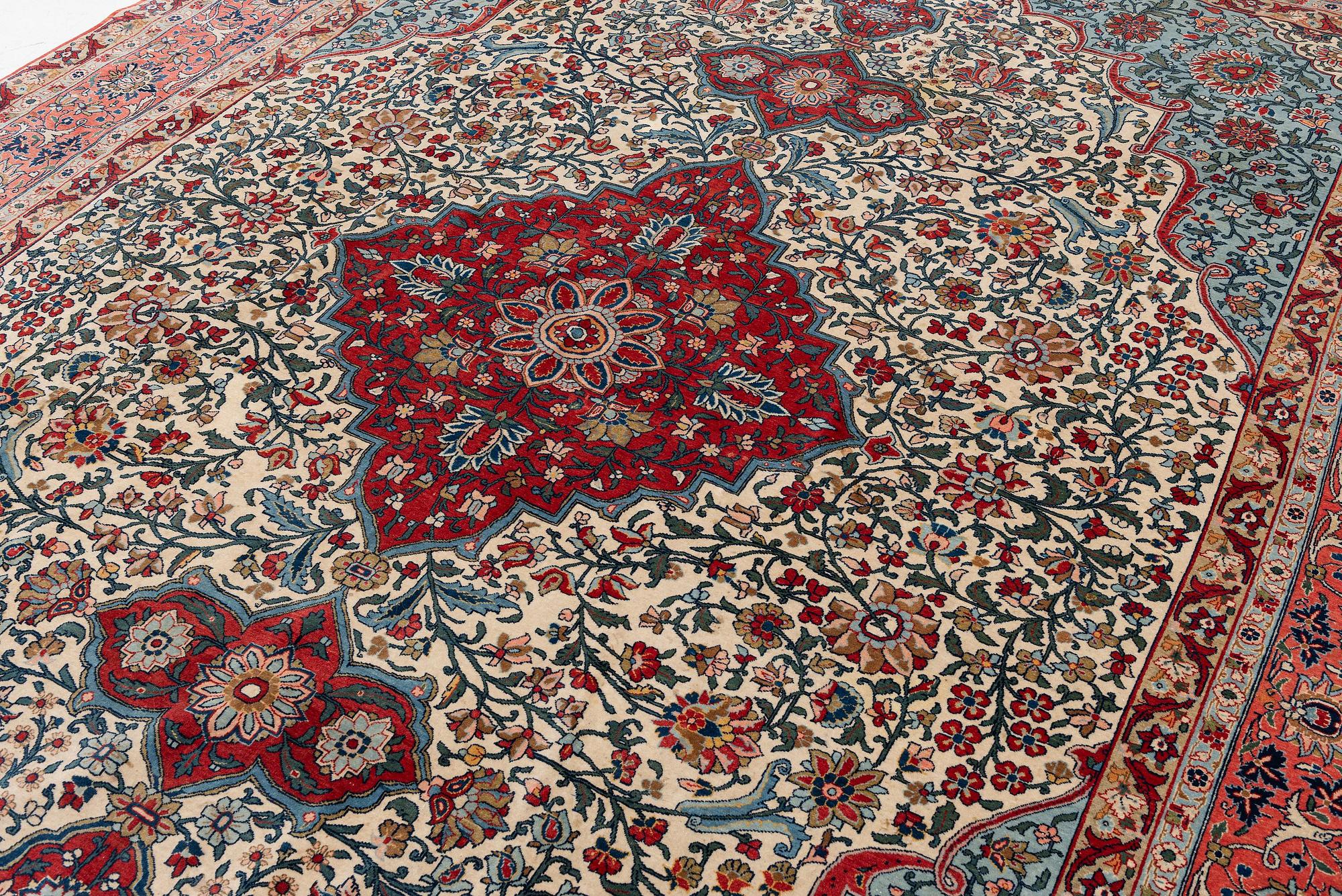 A semi-antique Qum carpet. Central Persia, c. 345 x 258 cm.