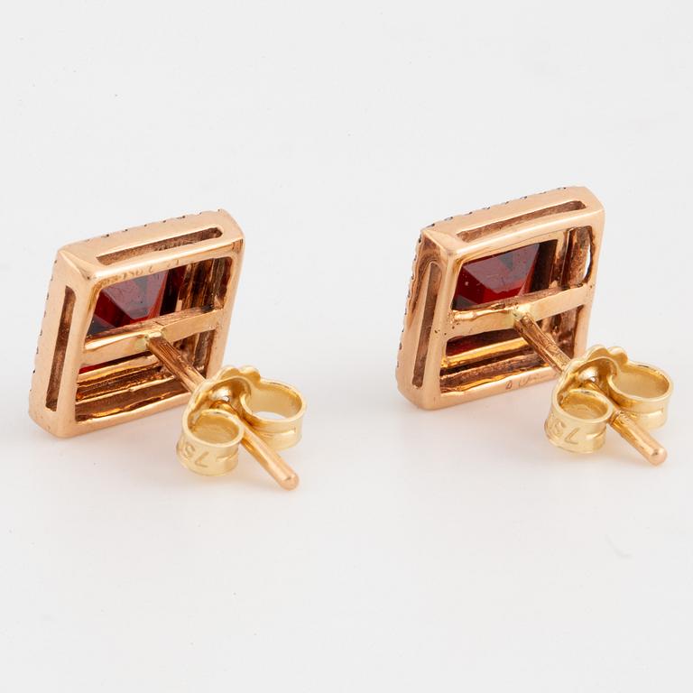 18K gold earrings with step-cut garnets and brilliant-cut diamonds.