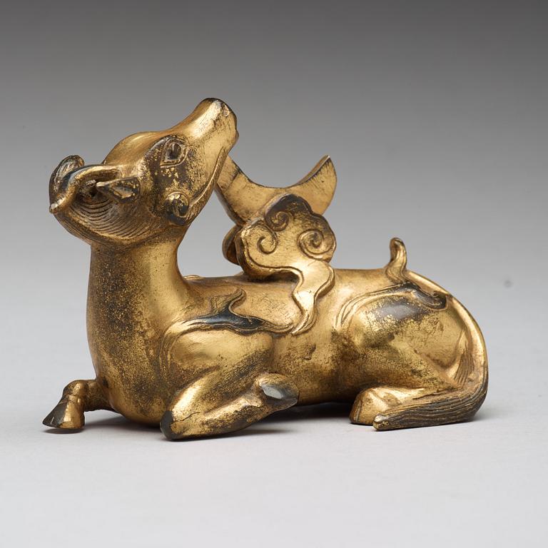 A gilt bronze figure of a reclining mythical animal, Qing dynasty, 19th Century.
