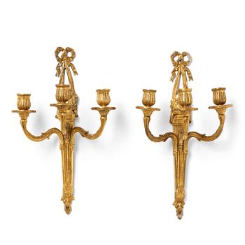 87. A pair of North European Louis XVI gilt bronze three-branch appliques, late 18th century.
