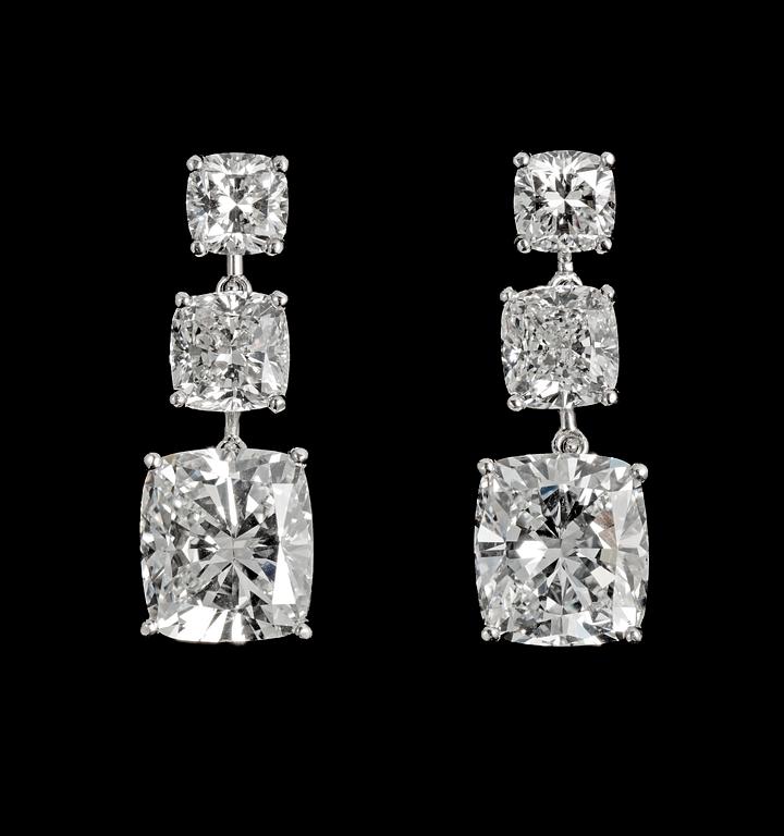 A pair of cushion cut diamond earrings, larger stones 3.01 cts/resp 3.03 cts, tot. 9 cts.