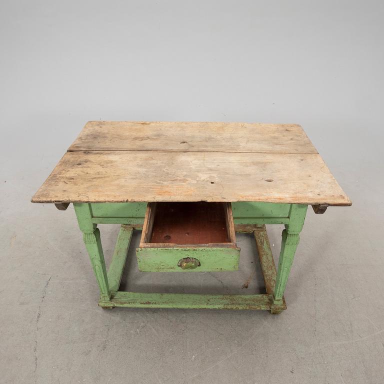 A painted wooden table from the first half fo the 20th century.