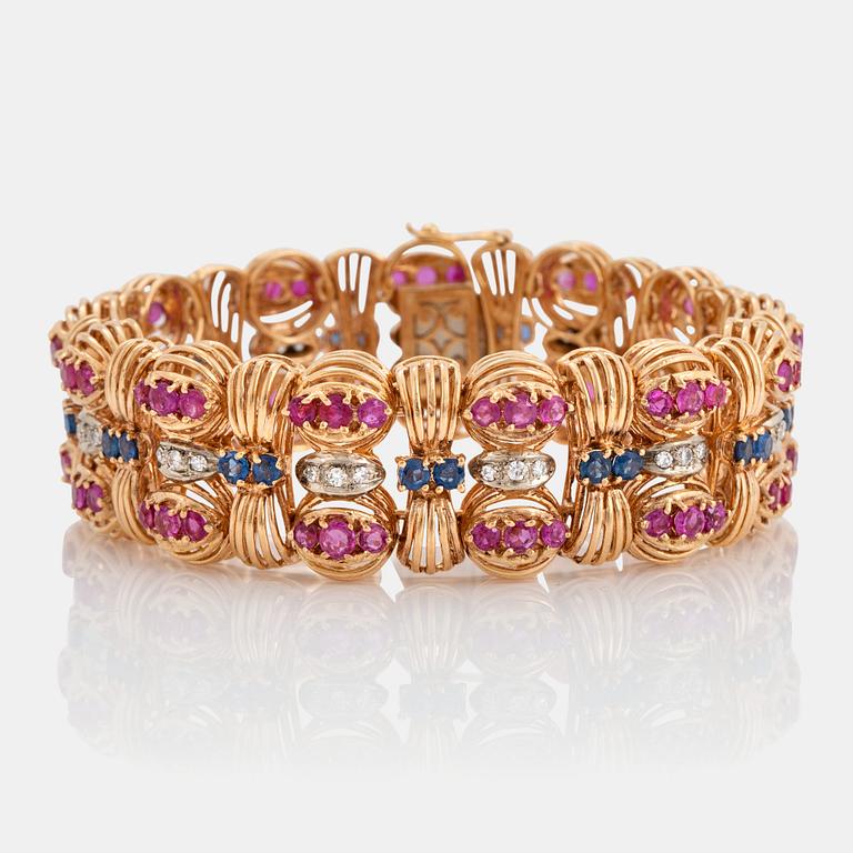 An 18K gold Bucherer bracelet set with blue and pink sapphires and round brilliant-cut diamonds.