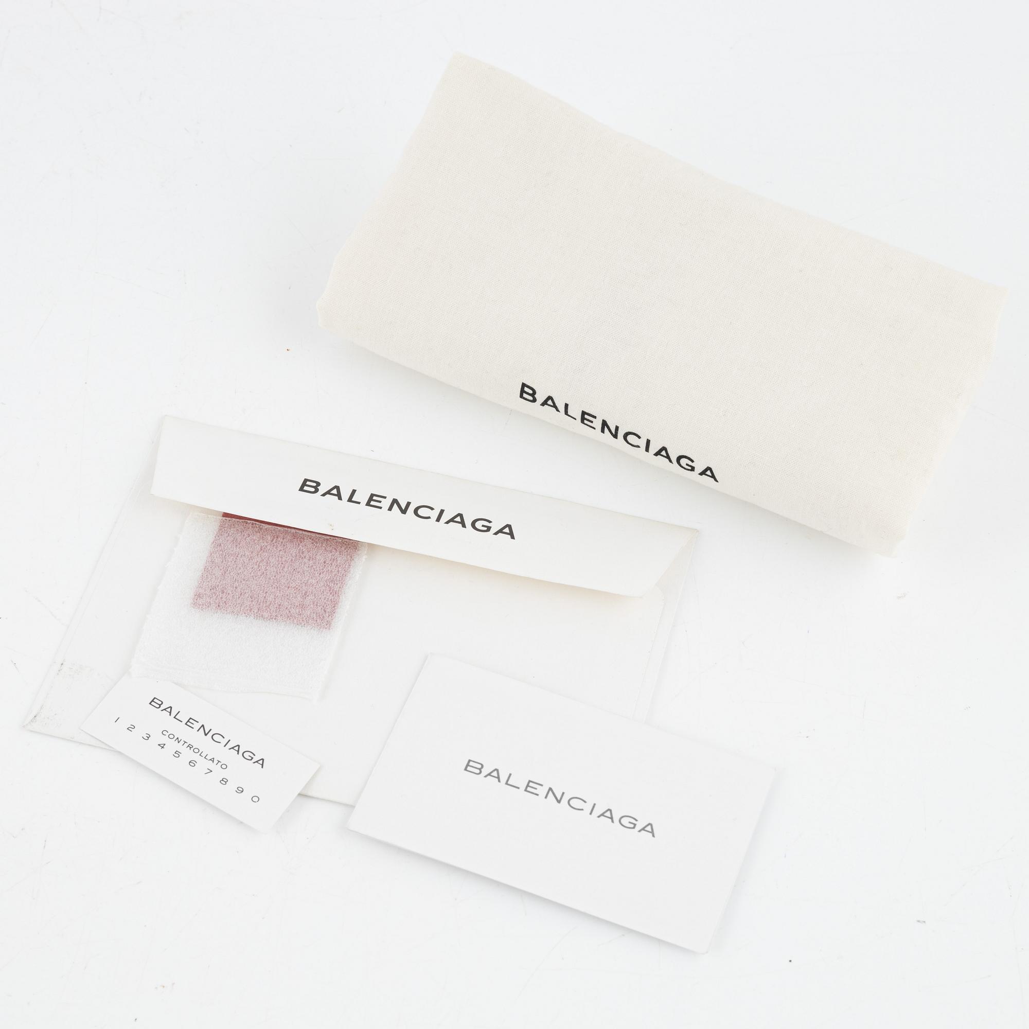 Balenciaga, a pink leather clutch.