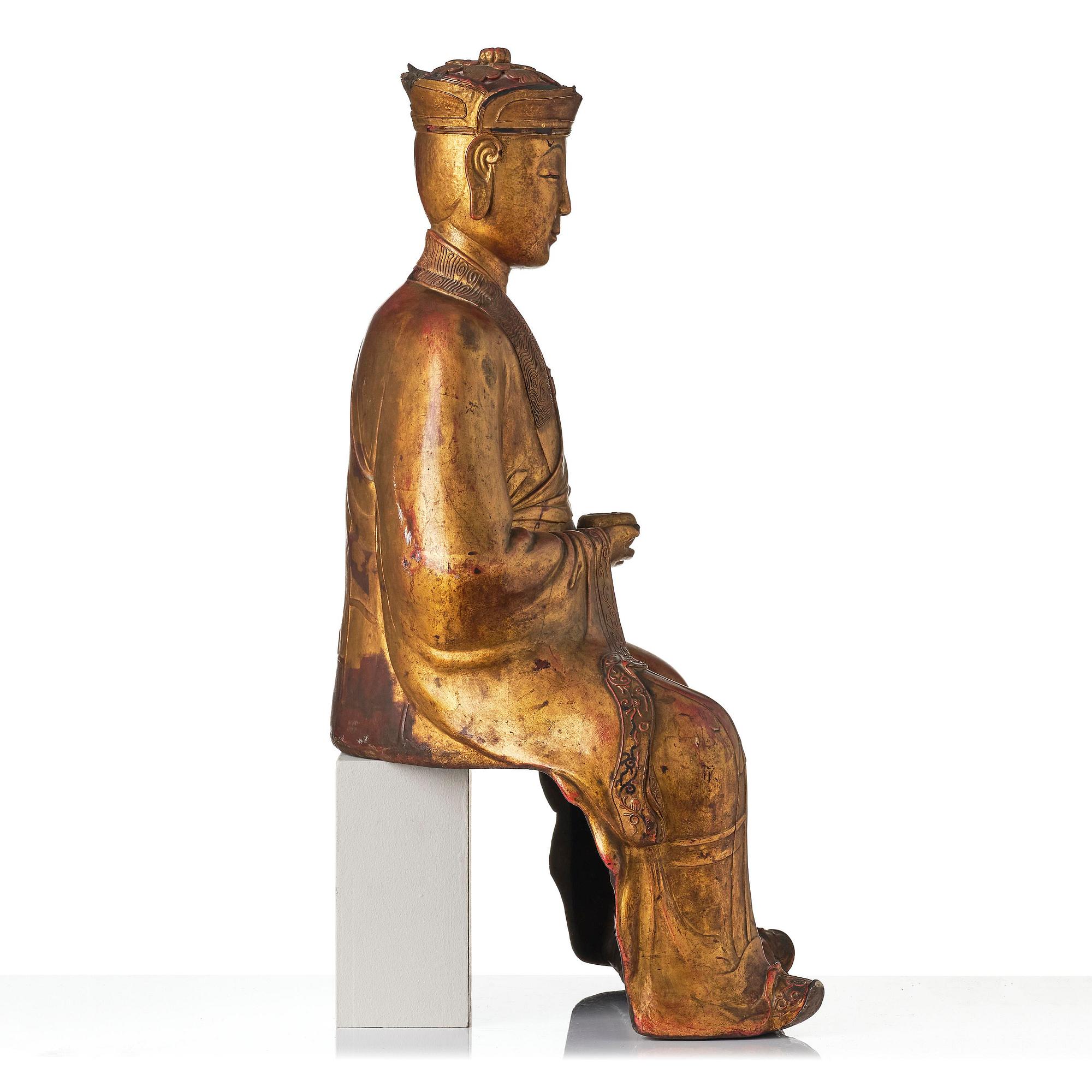 A large gilt lacquer figure of a deity, Vietnam, 19th century.