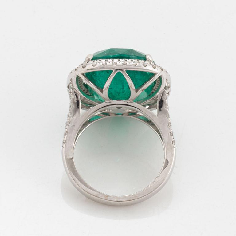An 18K white gold ring set with a faceted emerald.