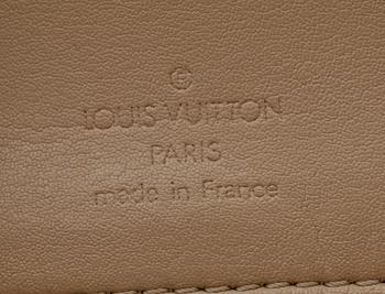 A beige monogram vernis handbag by Louis Vuitton.