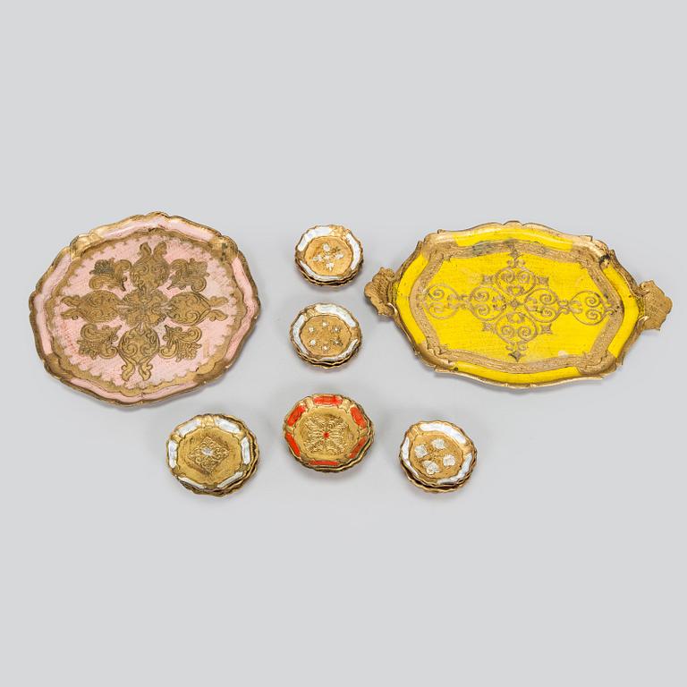An Italian, mid-20th-century nesting table, two trays, and coasters for bottles and glasses, 18 pieces.