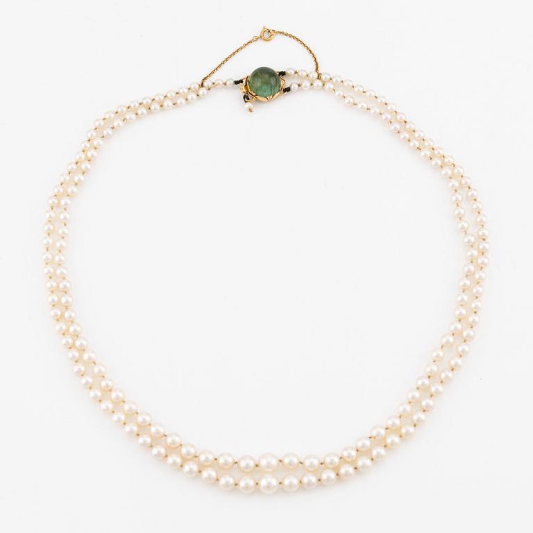 Pearl necklace, double-stranded with graduated cultured pearls, with an 18K gold clasp and cabochon-cut green tourmaline.