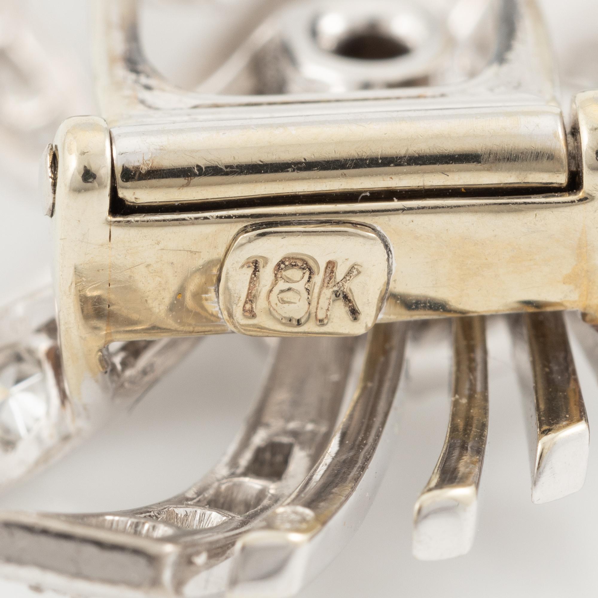 Brooch/clip 18K white gold set with round brilliant-cut and eight-cut diamonds.