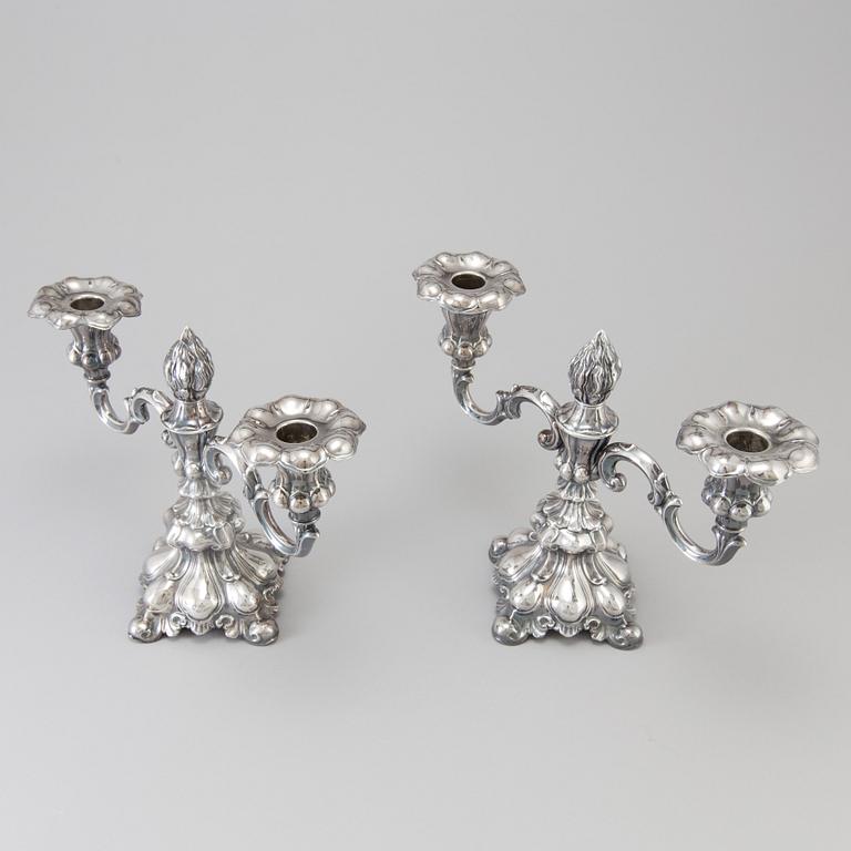 A pair of Swedish Rococo style silver candelabras from C G Hallberg in Stockholm 1955 and 1959.