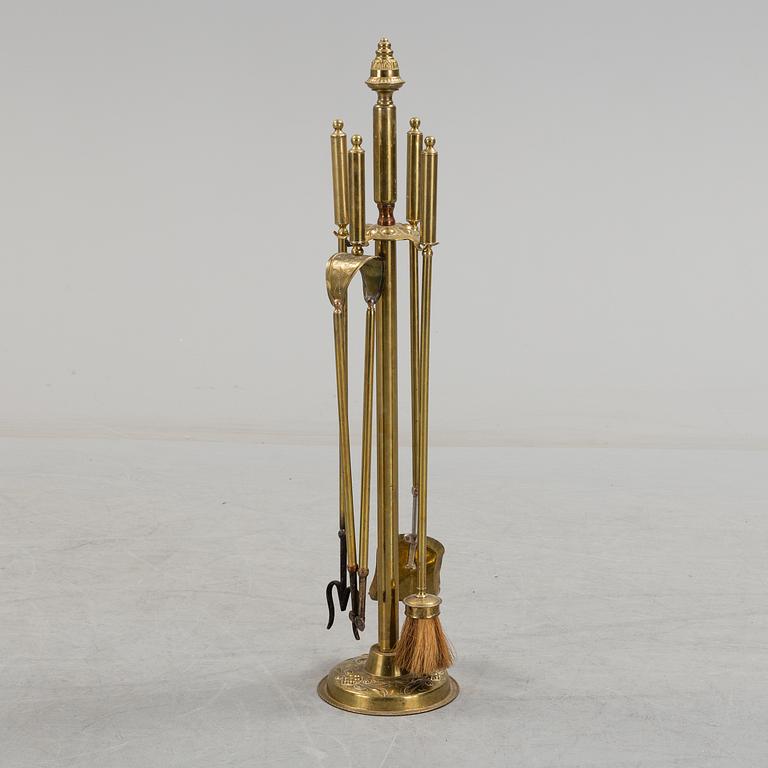 A set of 4 brass fire utensils with stand, 20th Century.