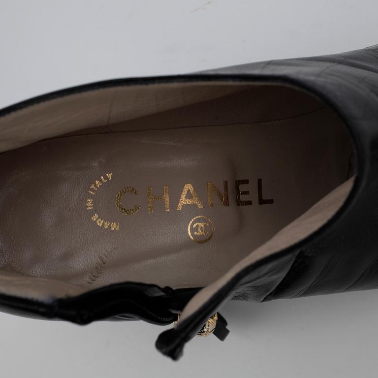CHANEL, a pair of black leather boots.