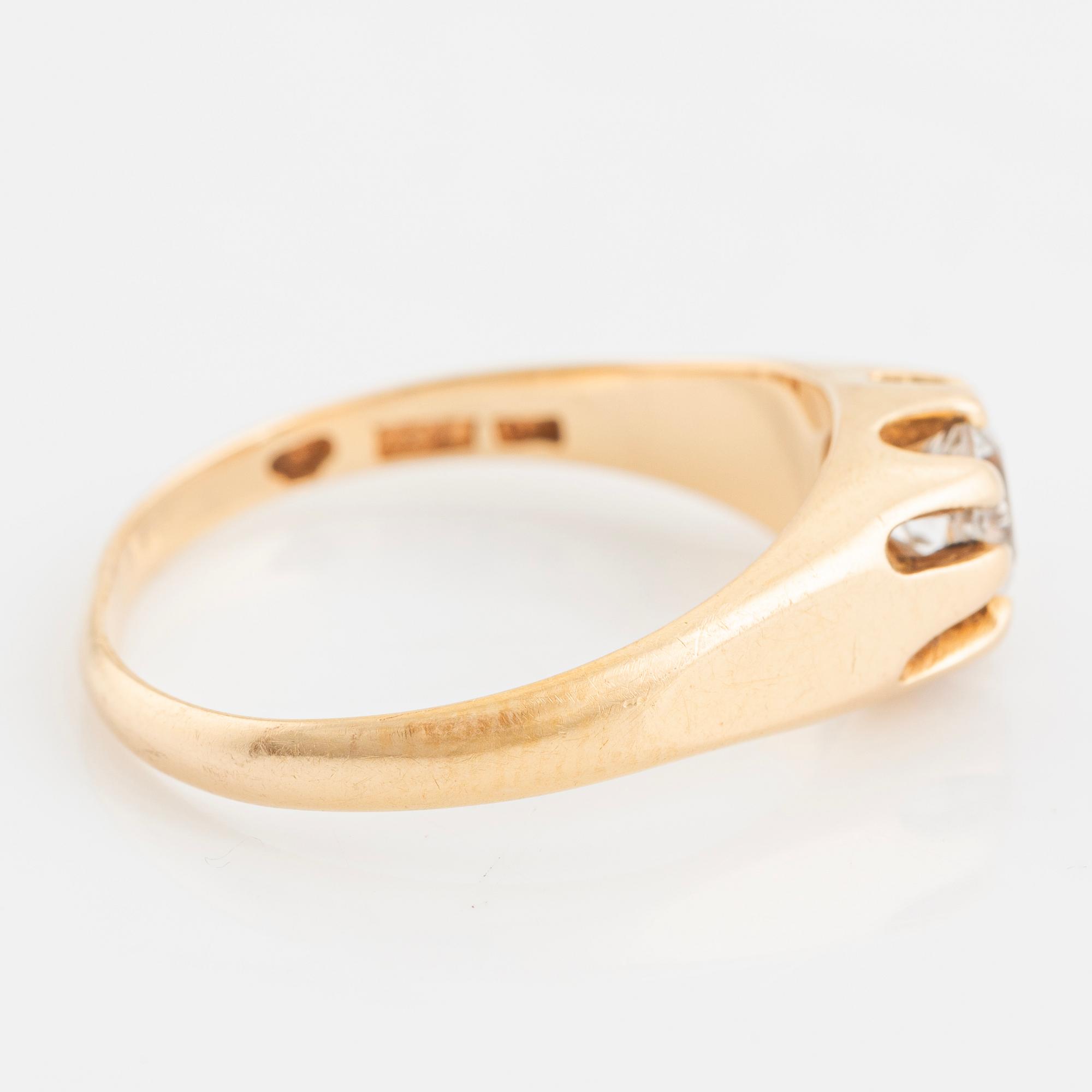 Ring, with faceted white stone.