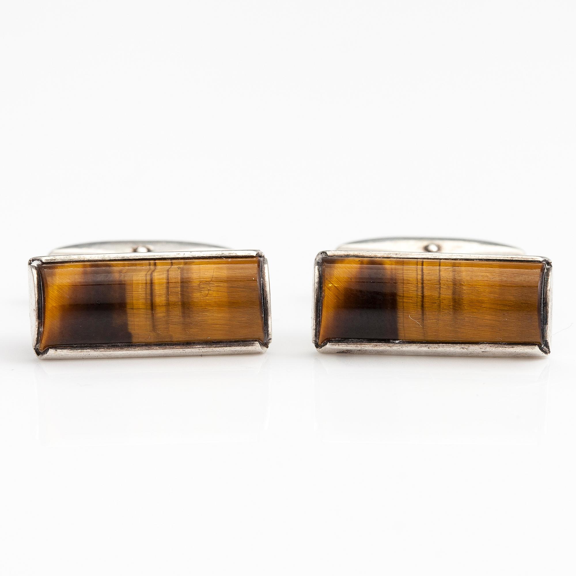 A set of three pairs of silver cufflinks with hematite, tigers eye and granite. Turun Hopea and Osvald Mättö.