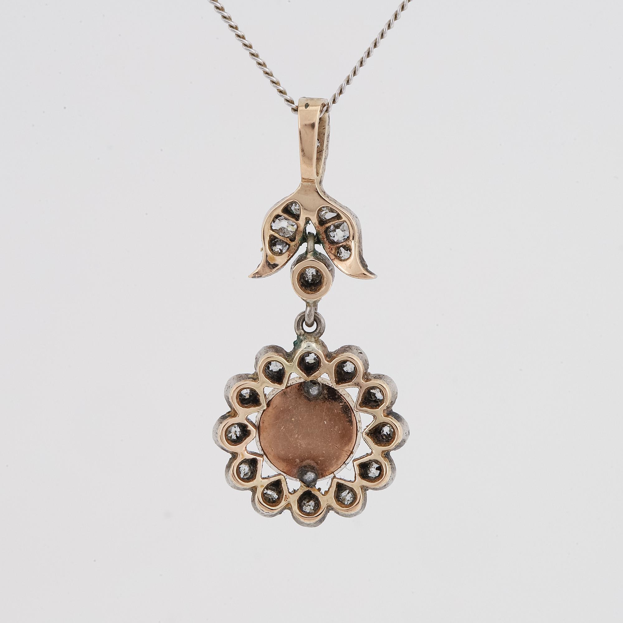Old-cut diamond and pearl pendant.