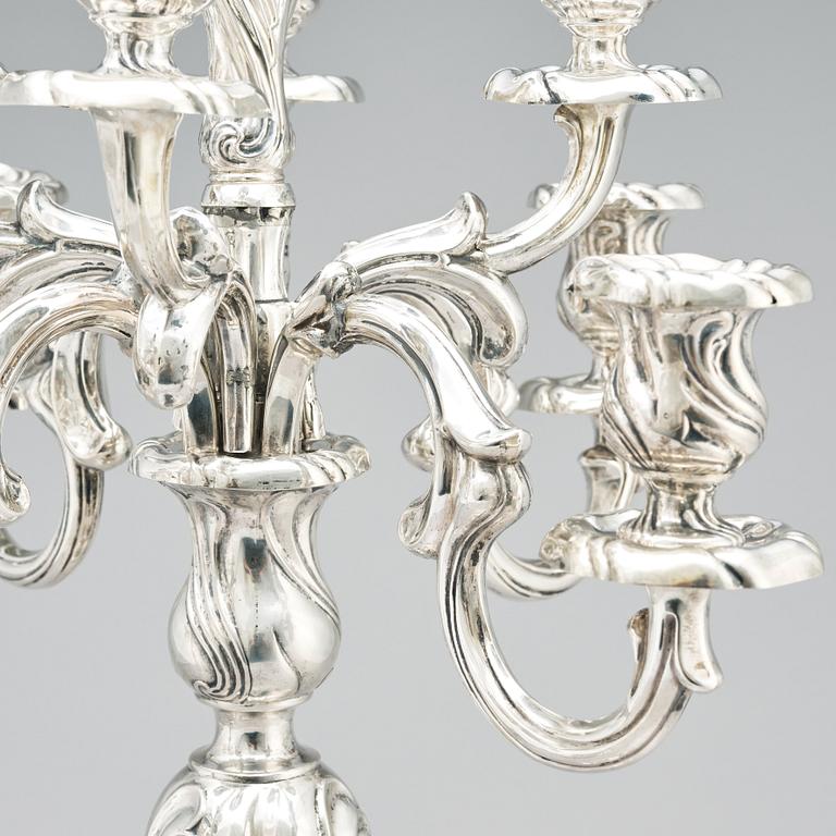 A pair of eight-light Louis XV-style silver candelabra, mark of Hermann Julius Wilm, Berlin, circa 1900.