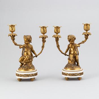 A pair of Louis XVI style gilt bronze and marble two light candelabras, circa 1900.