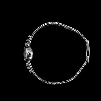 DAMARMBANDSUR, 18k vitguld med 6 briljantslipade dia, Juwel. 1970-tal. Tot.vikt 23g.