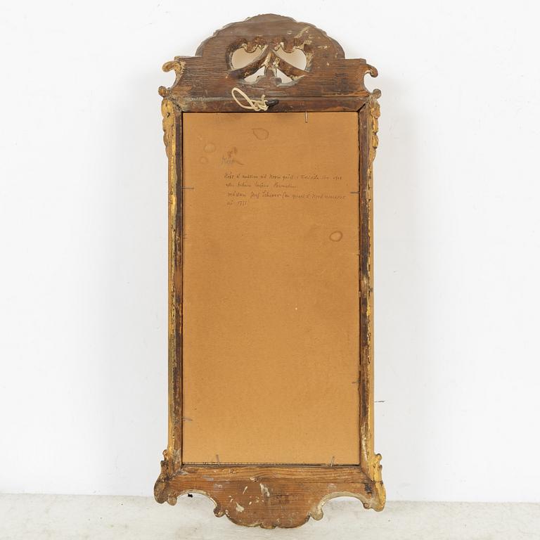 A giltwood rococo mirror by J. Schürer (master in Stockholm 1769).
