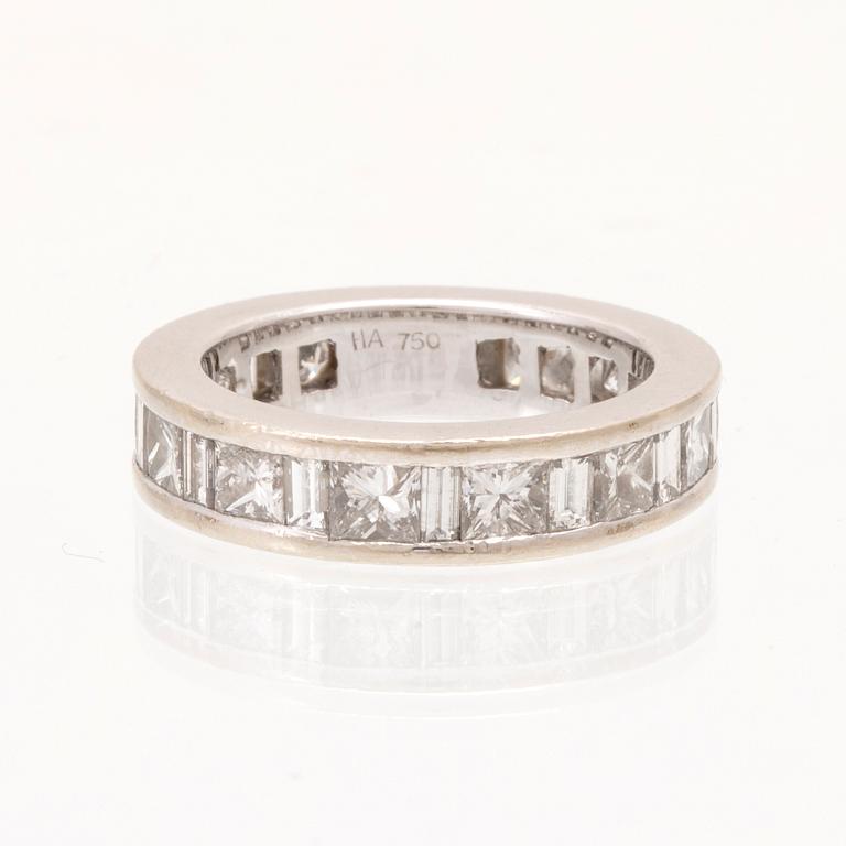 An 18K white gold eternity ring set with baguette and princess cut diamonds by Hartmann's Denmark.