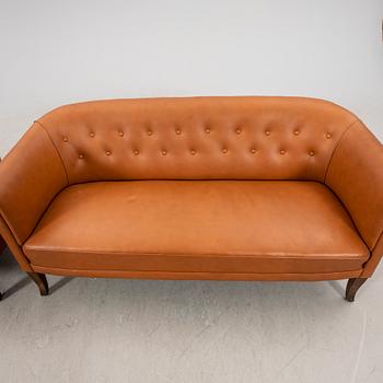 A leather sofa and armchair 1940s.