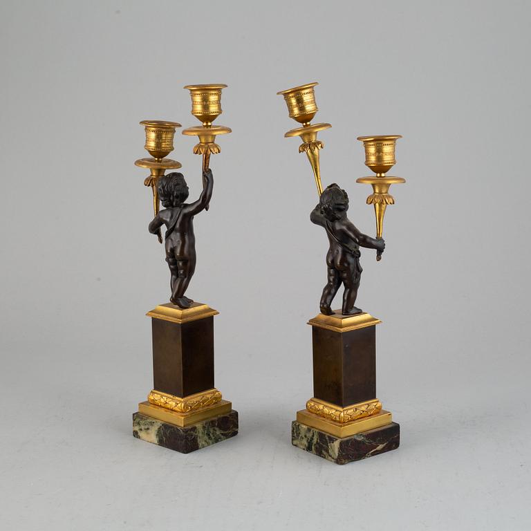 A pair of bronze empire style candleabra, 20th century.