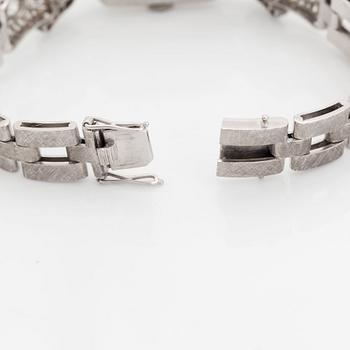 A bracelet/watch in platinum and 18K white gold set with old- and eight-cut diamonds.