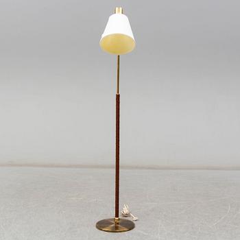 a brass and leather floor lamp from the second half of the 20th century.