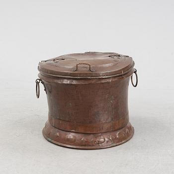 A copper water container, dated 1706.