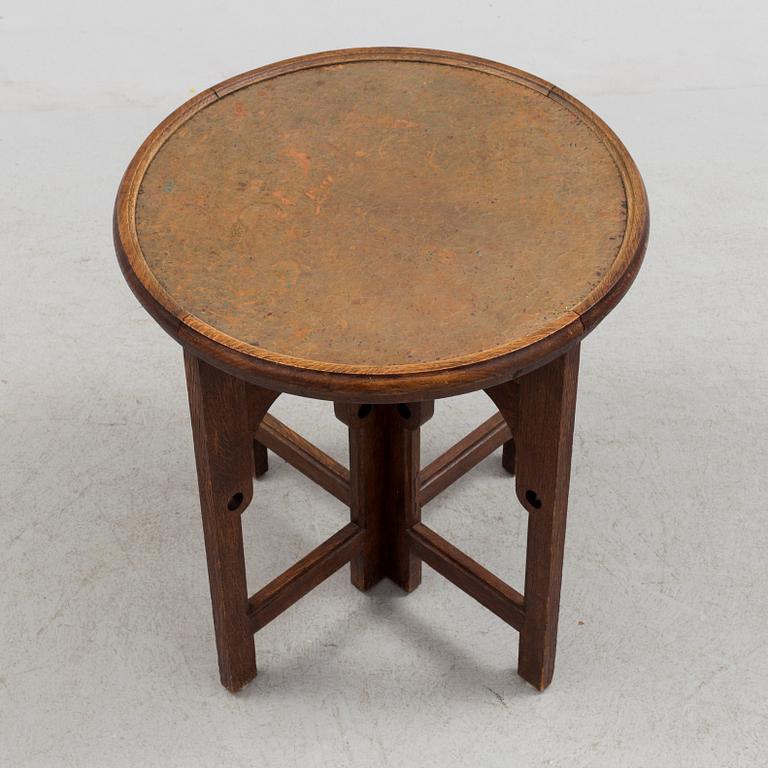 NORDISKA KOMPANIET, an Art Nouveau copper and oak smoking table, 1913.