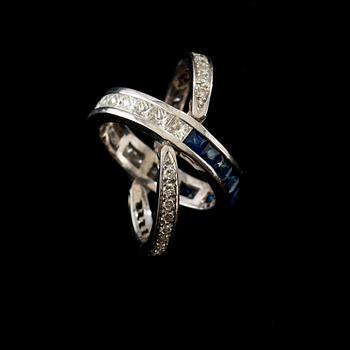 A diamond, circa 1.00 ct, and sapphire ring. Flexible parts.