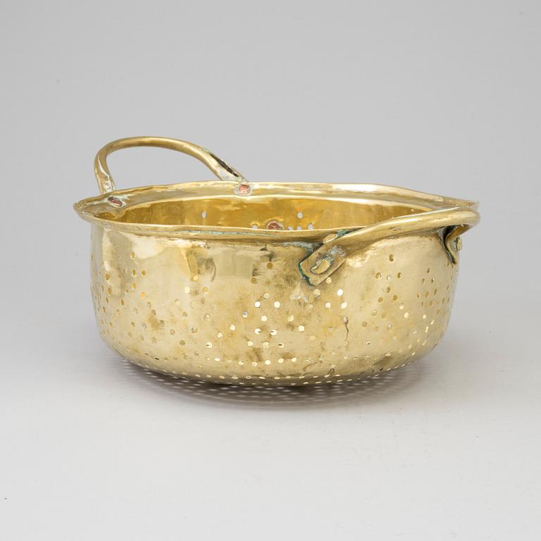 A 19th century brass colander.