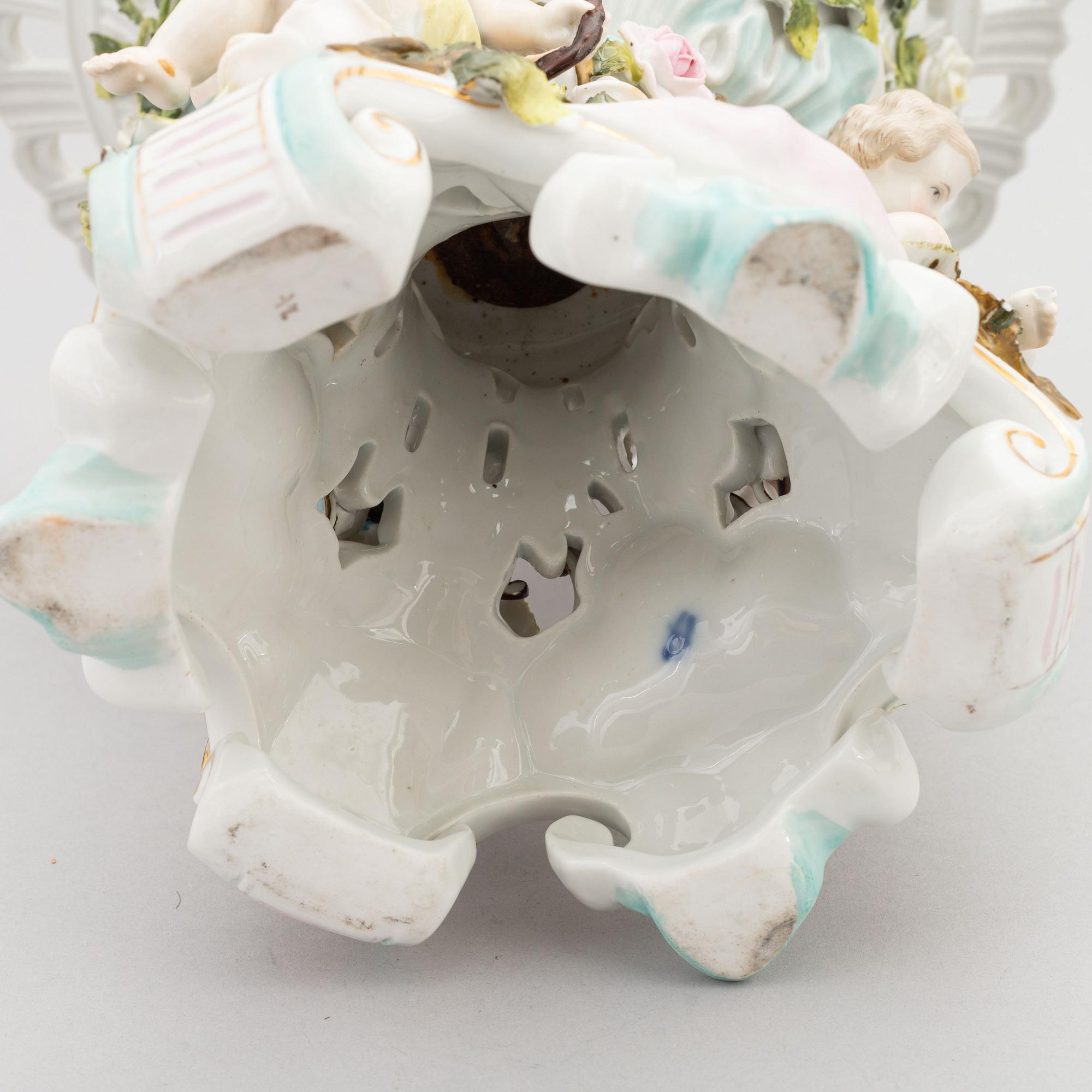 A pair of porcelain rococo style candelabra and a centerpiece bowl, Plaue, Germany, first half of the 20th century.