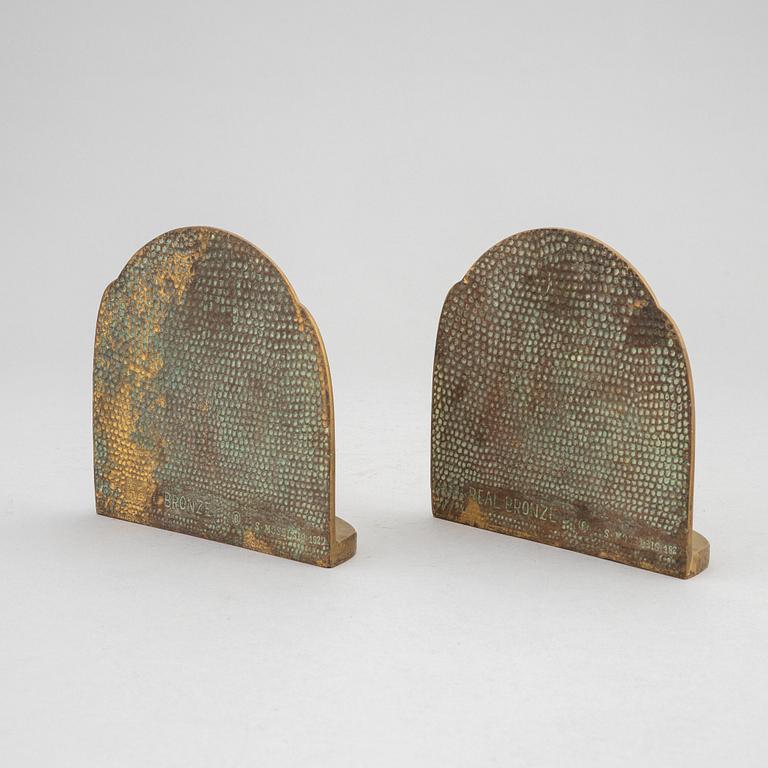 Simon Moselsio, a pair of bronze bookends, 20th Century.