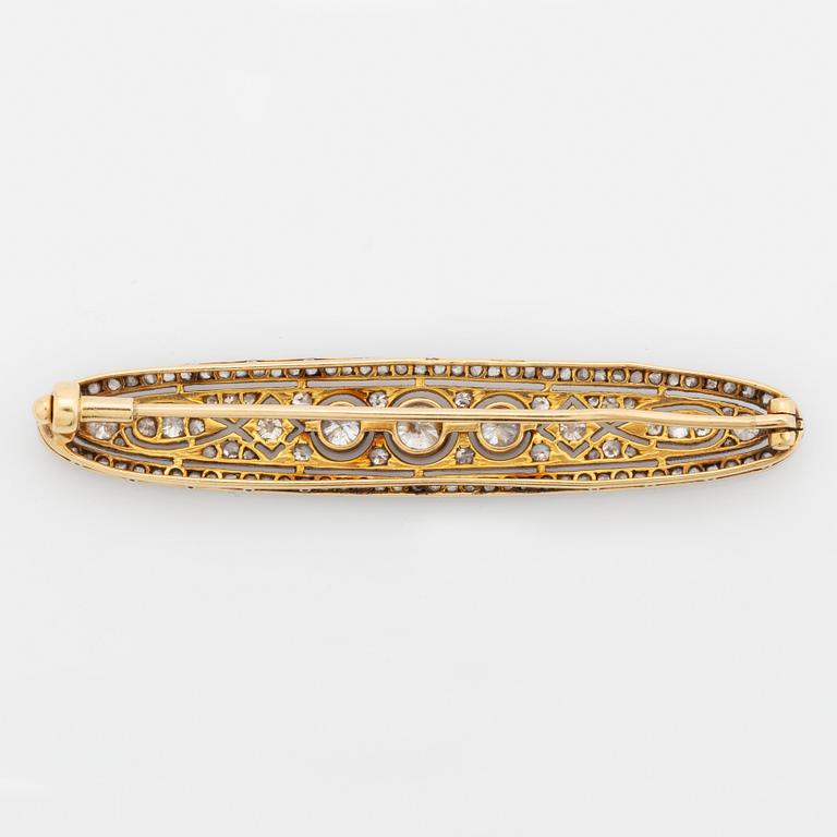 A platinum and 18K gold brooch set with old- and rose-cut diamonds.