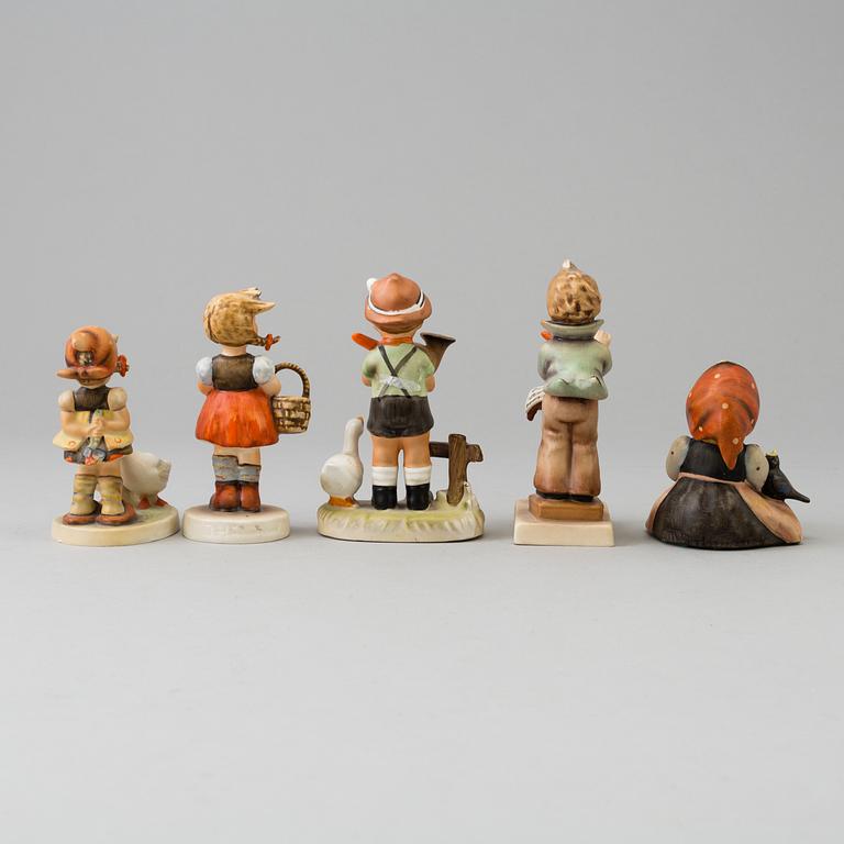 Five porcelain figurines, mostly Goebel.