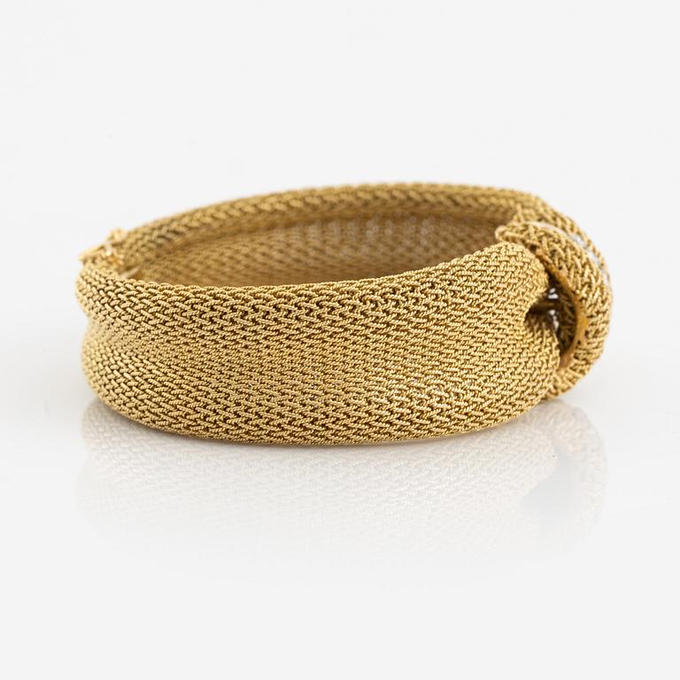 An 18K gold Bucherer bracelet set with round brilliant-cut diamonds.