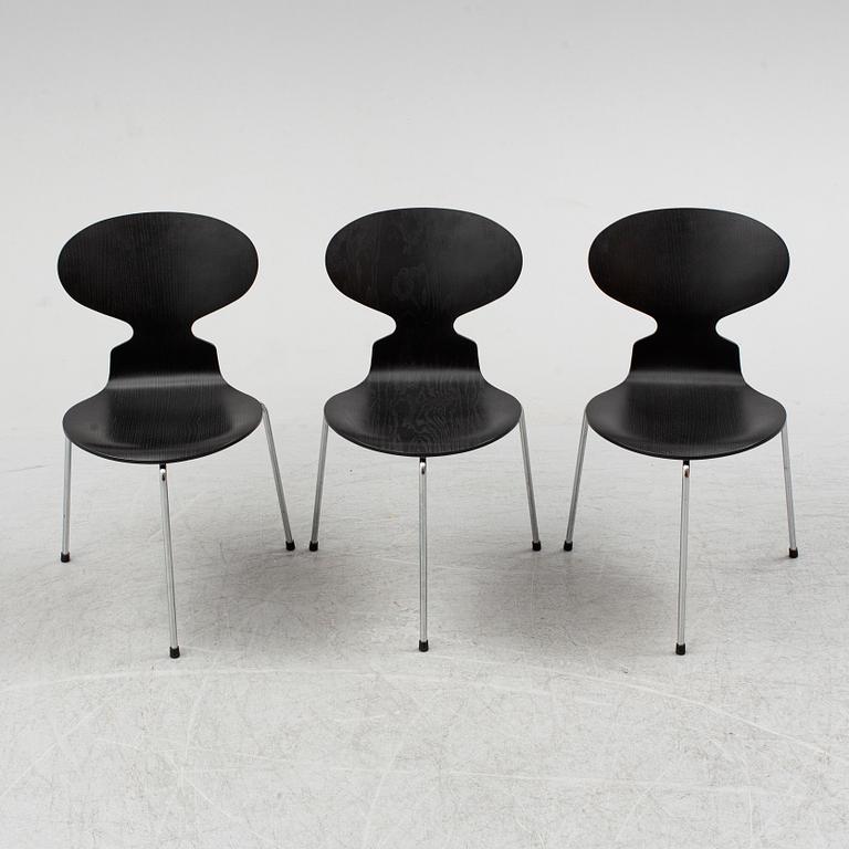An Arne Jacobsen "Centenary Package" comprising three "Ant Chairs" and an eggshaped table, Fritz Hansen, Denmark.