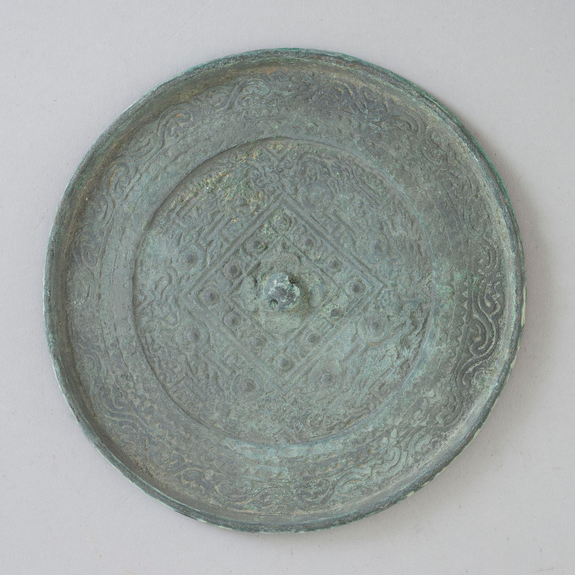 A bronze mirror, Xin-Eastern Han dynasty (9-220).
