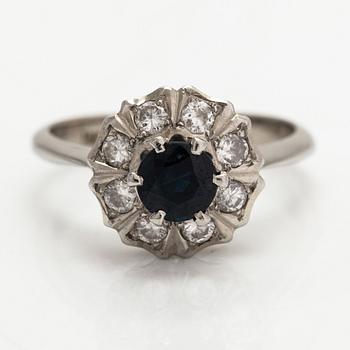 An 18K white gold ring with diamonds ca. 0.24 ct in total and a sapphire. Finnish import marks.