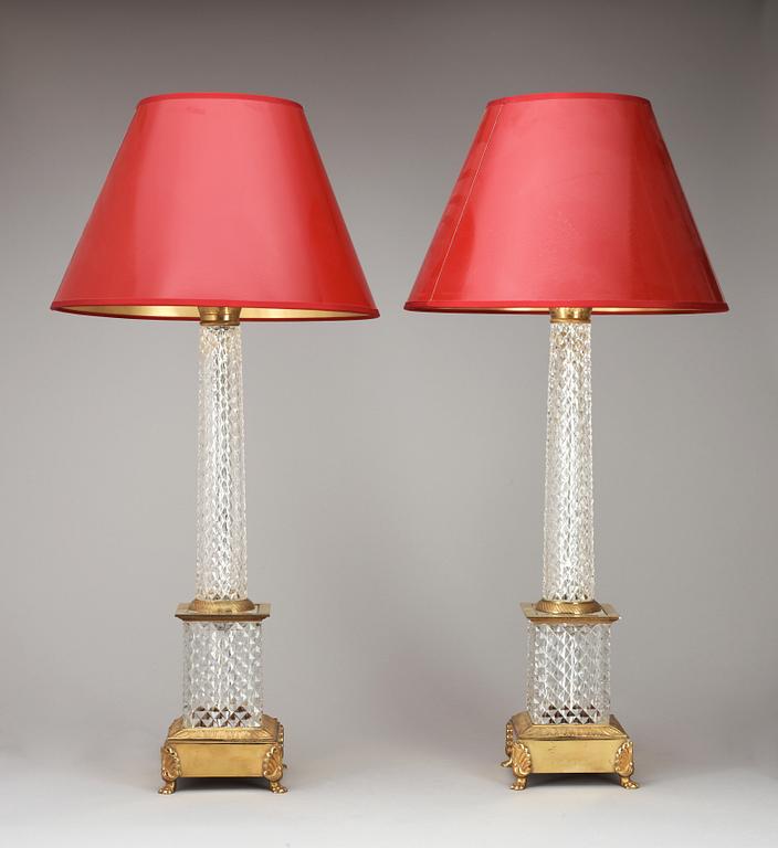 A pair of 20th cent cut glass and brass table lamps.