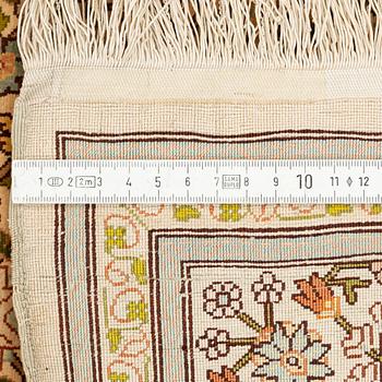 A silk Hereke rug, circa 104 x 70 cm.